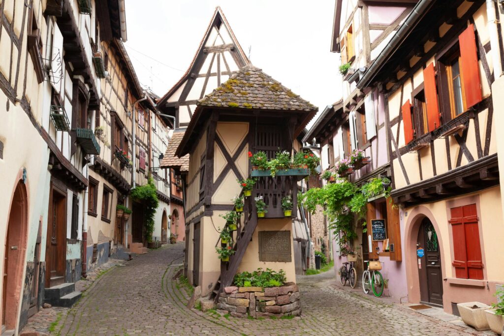 The colorful village of Eguisheim, France, with its half-timbered houses and vineyards.