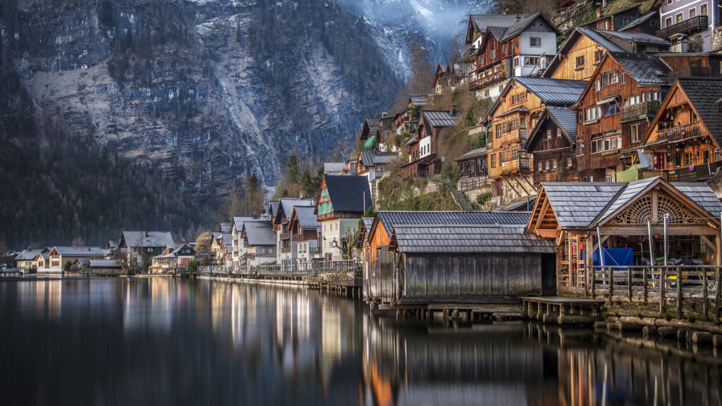 The charming lakeside village of Hallstatt, Austria, surrounded by mountains and water.