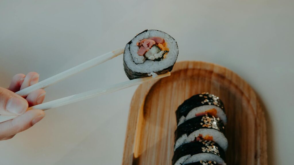 Korean street food  gimbap rolls filled with rice, vegetables, and meat, wrapped in seaweed.