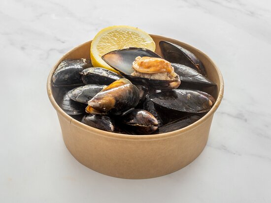 A tray of midye dolma served with lemon wedges